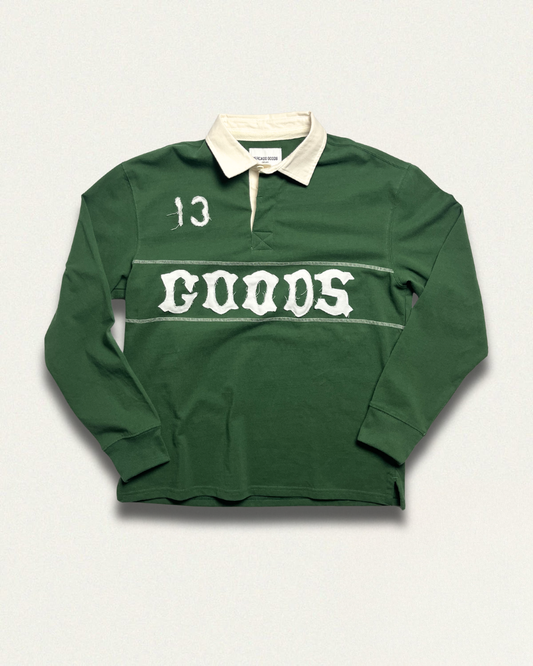 Green rugby jersey with 'GOODS' appliquéd on it, on a light gray background